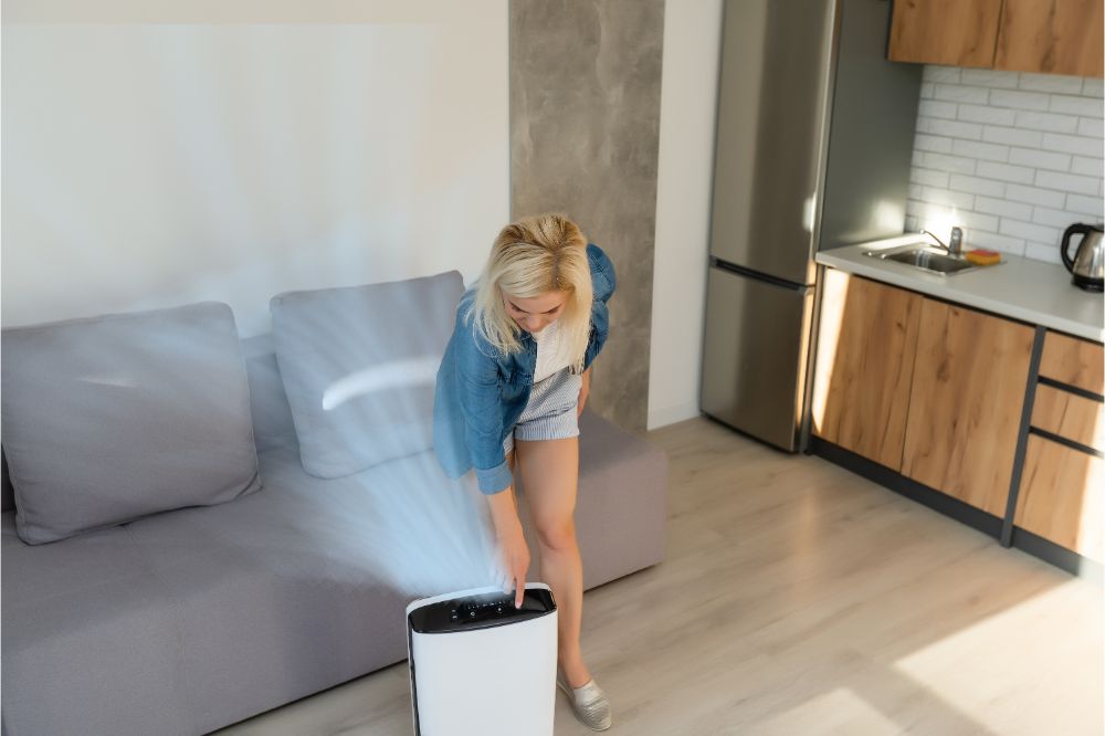 woman turning on the air purifier